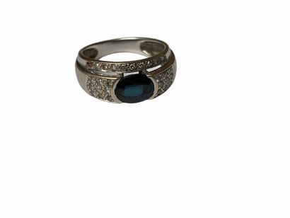18k white gold ring set with a blue stone...