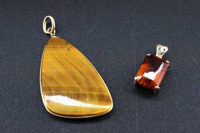 2 yellow hardstone pendants, the other adorned...