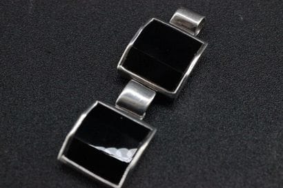 Silver pendant set with onyx in two square...
