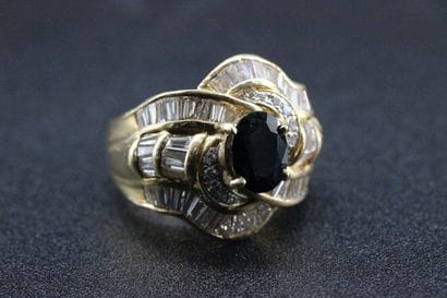 18k yellow gold ring set with a sapphire...