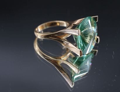 14K yellow gold ring set with a large stylized...