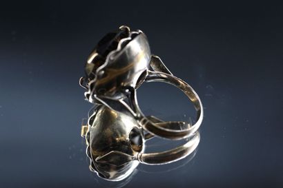 14K yellow gold ring set with a large dark...