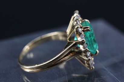 Yellow gold ring set with an emerald-cut...