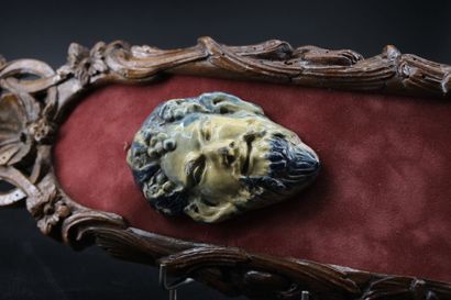 2 terracotta mascarons, one stylizing Bacchus...