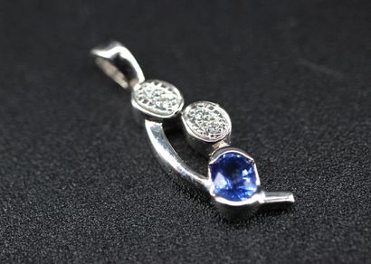 18k white gold pendant set with a blue stone...