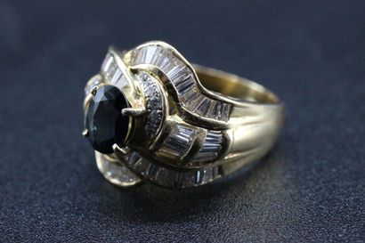 18k yellow gold ring set with a sapphire...