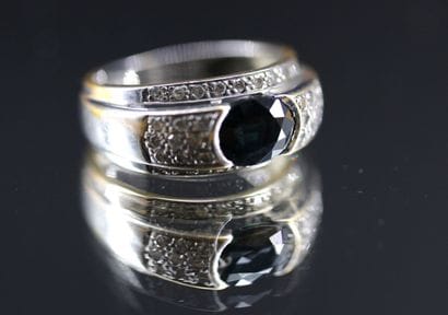 18k white gold ring set with a blue stone...