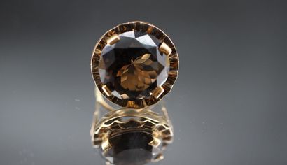 14K yellow gold ring set with a large dark...