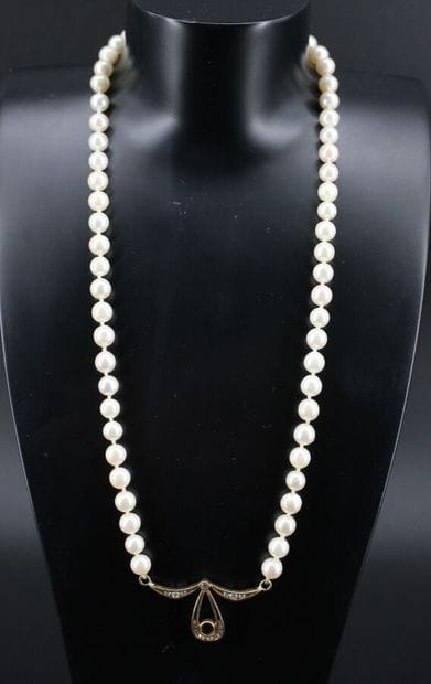 Cultured pearl necklace adorned with an 18k...