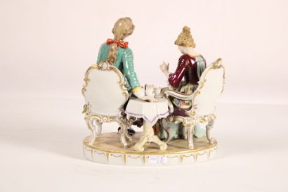 Painted porcelain group with gold highlights...