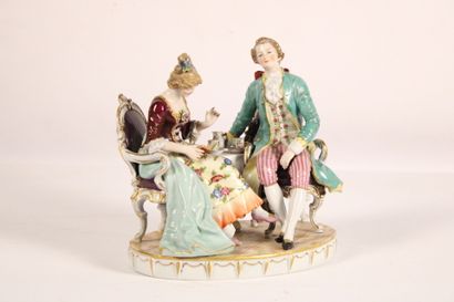 Painted porcelain group with gold highlights...
