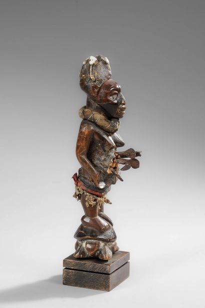 Kongo mother carrying her child on her side
Wood,...