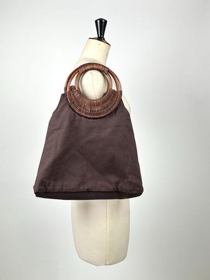 GUERLAIN
Chocolate canvas bag with oval woven...