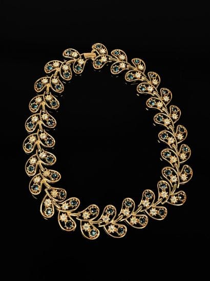 Gilded metal necklace in leaves adorned with...