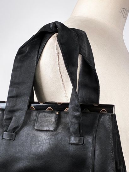 GUERLAIN
Chocolate canvas bag with oval woven...