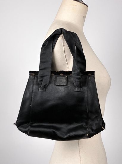 GUERLAIN
Chocolate canvas bag with oval woven...