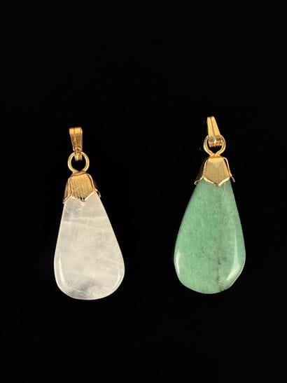 Set of two hard stone pendants with gilded...