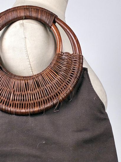 GUERLAIN
Chocolate canvas bag with oval woven...
