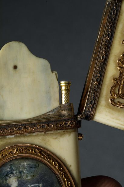 A dance card and its gold stylus in a bone...