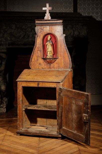 A carved, molded oak oratory surmounted by...