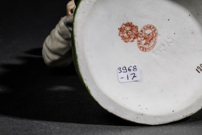 Polychrome porcelain figurine depicting a...