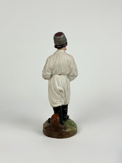 Polychrome porcelain figurine depicting a...