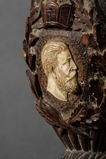 A large wooden and horn pipe with a bowl...