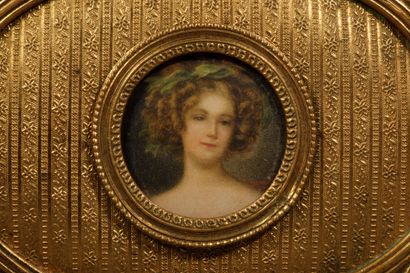 A small, oval-shaped jewelry box made of...