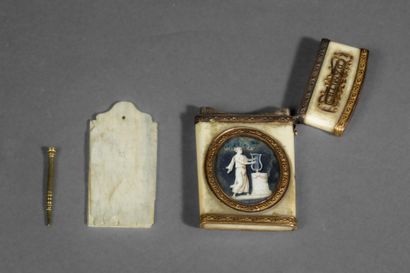A dance card and its gold stylus in a bone...