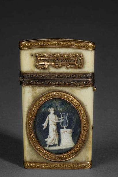 A dance card and its gold stylus in a bone...