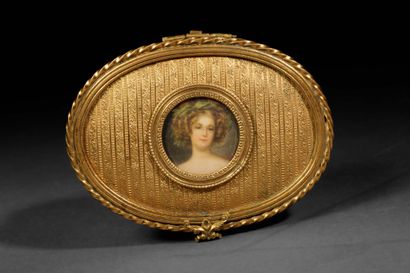 A small, oval-shaped jewelry box made of...