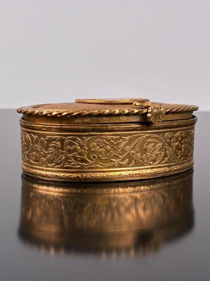 A small, oval-shaped jewelry box made of...