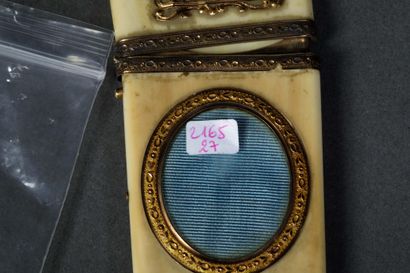 A dance card and its gold stylus in a bone...