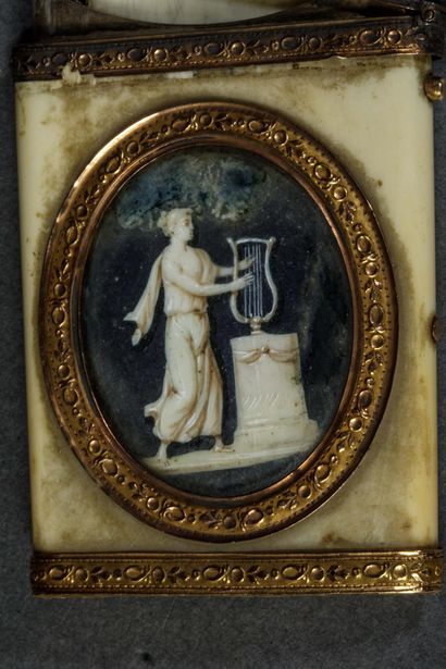 A dance card and its gold stylus in a bone...