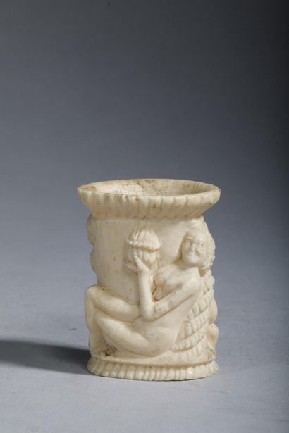 Small bone jar carved with two figures—a...