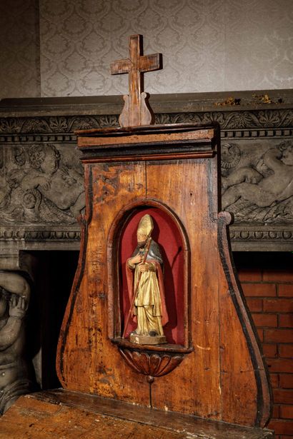 A carved, molded oak oratory surmounted by...