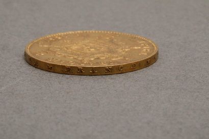Une pièce de 100 francs or Napoléon III tête...