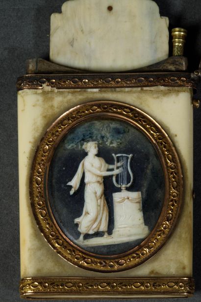 A dance card and its gold stylus in a bone...