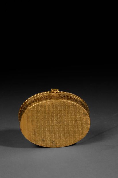 A small, oval-shaped jewelry box made of...