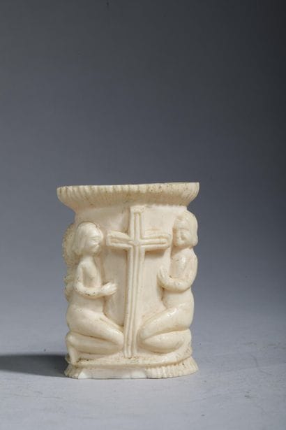 Small bone jar carved with two figures—a...
