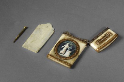 A dance card and its gold stylus in a bone...
