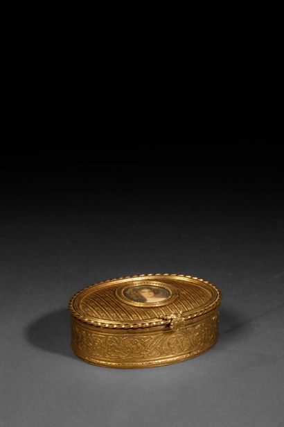 A small, oval-shaped jewelry box made of...