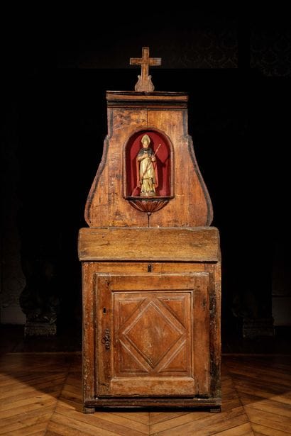 A carved, molded oak oratory surmounted by...