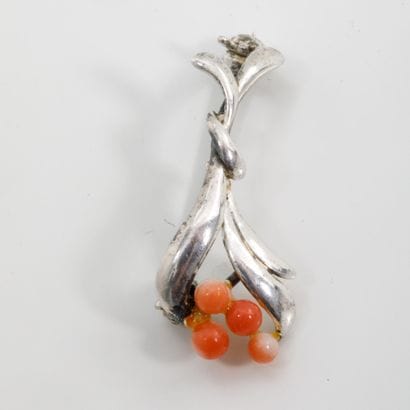 Small silver plated pin brooch featuring...
