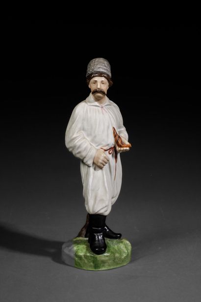 Polychrome porcelain figurine depicting a...