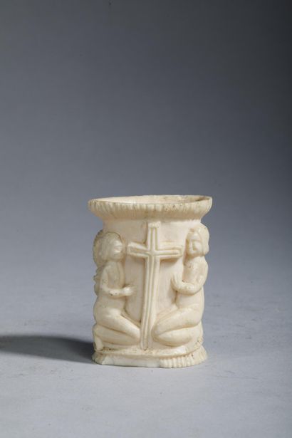 Small bone jar carved with two figures—a...