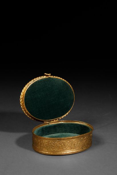 A small, oval-shaped jewelry box made of...
