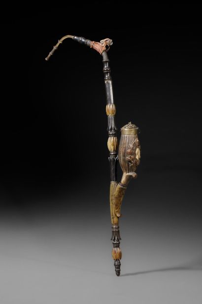 A large wooden and horn pipe with a bowl...