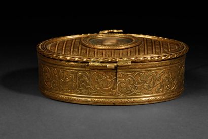 A small, oval-shaped jewelry box made of...