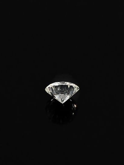 Round brilliant-cut diamond on paper weighing...